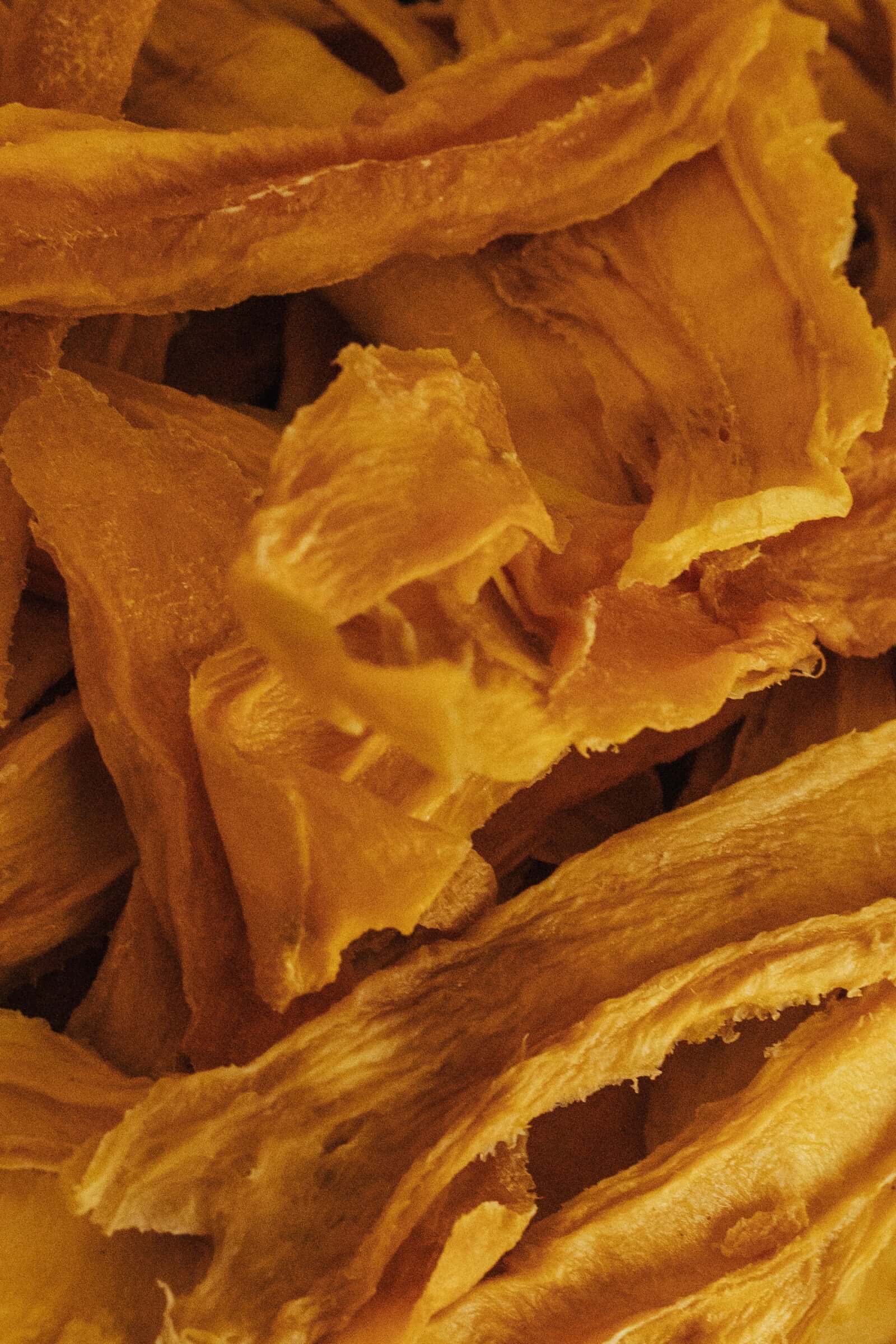 bright yellow organic dried mango strips, the perfect natural snack